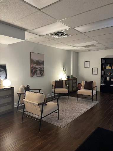 Clear Moon Therapy waiting area in Etobicoke — soft seating, wood floor, moon artwork
